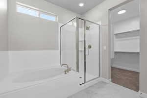 Bathroom featuring separate shower and tub