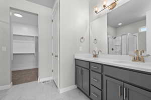 Bathroom featuring vanity and an enclosed shower