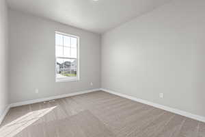 Carpeted empty room featuring a textured ceiling