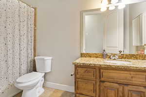 Bathroom featuring vanity, toilet, and tile patterned floors