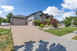 View of front facade featuring a garage and a front yard