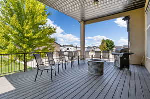 Wooden terrace featuring an outdoor fire pit