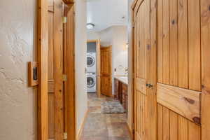 Bathroom with vanity, tile patterned floors, and stacked washing maching and dryer