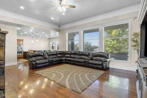 Living room featuring ornamental molding, ceiling fan, and hardwood / wood-style floors