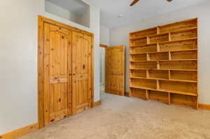 Carpeted bedroom with ceiling fan