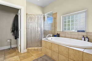 Bathroom with tile patterned flooring and separate shower and tub