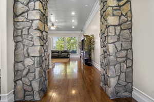 Hall with crown molding and hardwood / wood-style floors