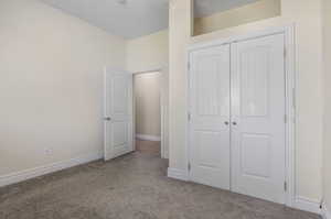 Unfurnished bedroom featuring a closet and carpet