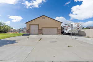 View of front facade with a front yard, a garage, and a playground