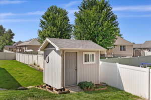 View of outbuilding with a yard