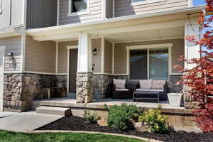 View of exterior entry featuring a porch and an outdoor living space