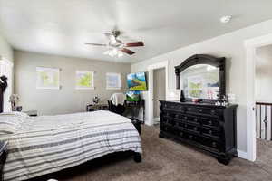 Carpeted bedroom featuring ceiling fan