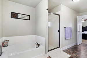 Bathroom featuring independent shower and bath and ceiling fan