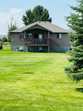 Back of house with a lawn