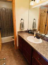 Full bathroom featuring tile patterned floors, shower / tub combo, vanity, and toilet