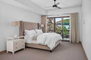 Bedroom featuring light colored carpet, access to exterior, and ceiling fan