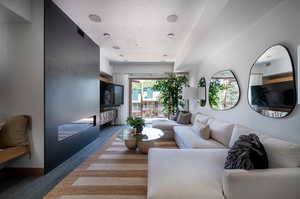 Living room with a textured ceiling and wood-type flooring