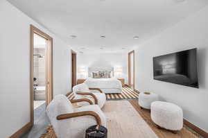 Bedroom featuring ensuite bath and a textured ceiling