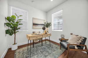 Office area featuring a healthy amount of sunlight and dark hardwood / wood-style flooring