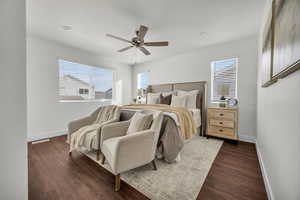 Bedroom with ceiling fan and dark wood-type flooring