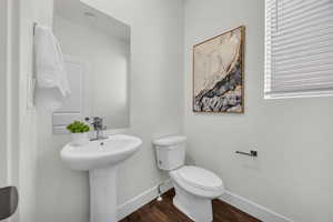 Bathroom featuring hardwood / wood-style flooring, toilet, and sink