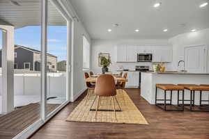 Dining space with dark hardwood / wood-style flooring and a textured ceiling