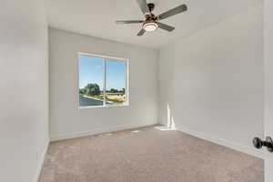 Unfurnished room with light colored carpet and ceiling fan