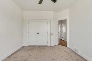 Unfurnished bedroom featuring light hardwood / wood-style floors, a closet, and ceiling fan