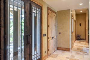 Foyer entrance with light tile patterned flooring and plenty of natural light