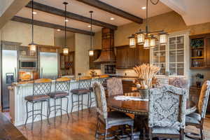 Dining area with beamed ceiling and wood-type flooring