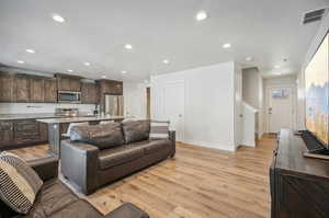 Living room with light wood-type flooring