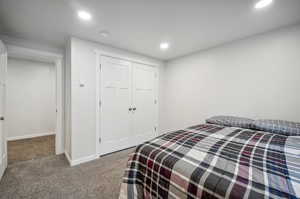 Carpeted bedroom featuring a closet