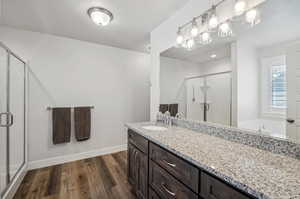 Bathroom featuring vanity, wood-type flooring, and independent shower and bath