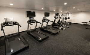 Gym featuring a textured ceiling