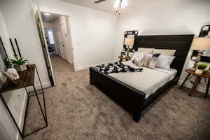 Bedroom featuring light carpet and ceiling fan