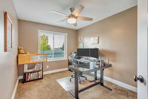 Carpeted home office with ceiling fan