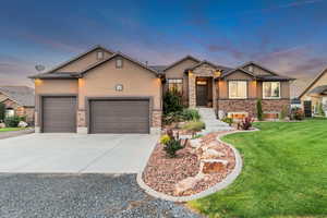 Craftsman inspired home with a garage and a lawn