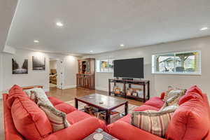 Living room with hardwood / wood-style flooring and a textured ceiling