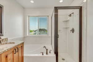 Bathroom with vanity and independent shower and bath