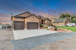 View of front of house featuring a garage and a yard