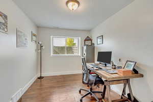 Office area with dark hardwood / wood-style floors