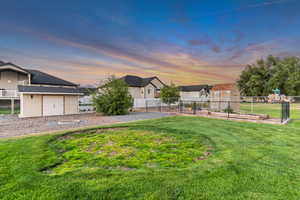 View of rear of property featuring a lawn.