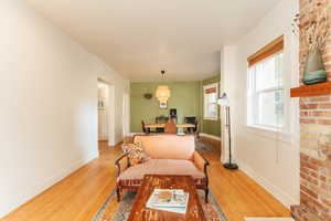 Dining area featuring radiator heating unit, hardwood flooring, and a wealth of natural light