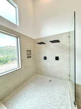 Bathroom featuring tiled shower