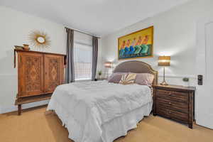 Bedroom featuring light colored carpet