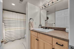 Bathroom featuring tile patterned floors, vanity, and toilet