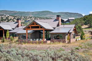 Rear view of house featuring a mountain view