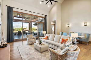 Living room featuring light wood-type flooring and high vaulted ceiling