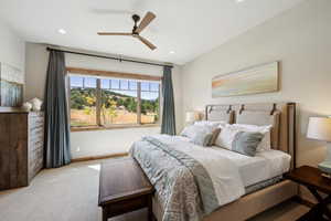 Carpeted bedroom featuring ceiling fan