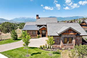 View of front facade with a front lawn and a mountain view